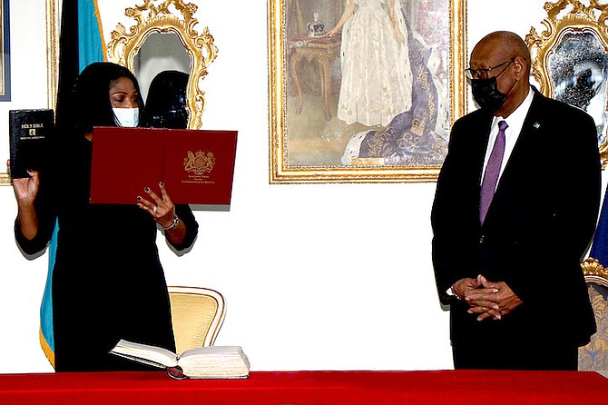 PAKESIA Parker-Edgecombe is sworn in as Minister of State for Disaster Preparedness, Management and Reconstruction by Governor General Sir C A Smith at the Office of the Governor General on Monday. (BIS Photos/Letisha Henderson)