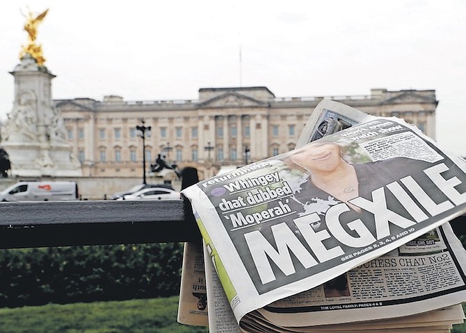 A NEWSPAPER is blown by the wind after it is placed on a railing by a television crew outside
Buckingham Palace in London. (AP Photo/Kirsty Wigglesworth, File)