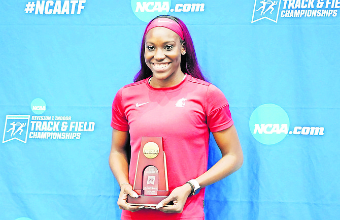 Charisma Taylor, holding her NCAA award, set a new national record in the triple jump.