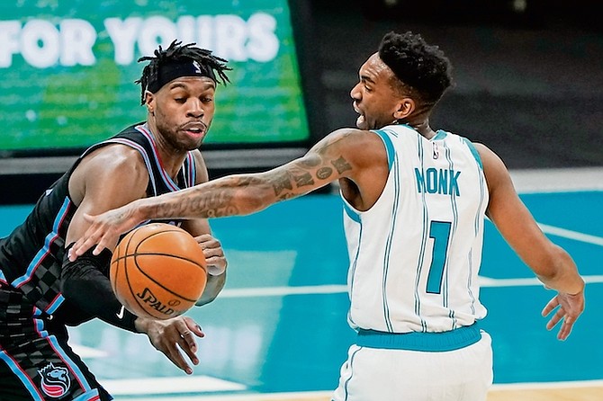 Sacramento Kings guard Buddy Hield, left, steals the ball from Charlotte Hornets guard Malik Monk during the first half yesterday in Charlotte, N.C.
(AP Photo/Chris Carlson)