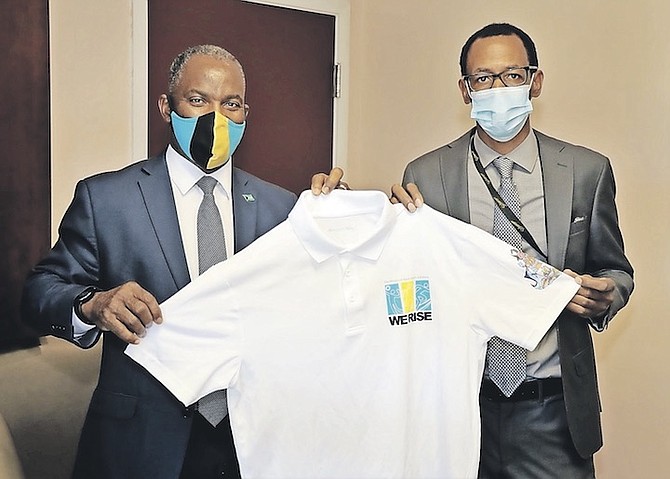 MINISTER of Youth, Sports and Culture Iram Lewis, left, and Director of Sports Tim Munnings display a ‘We Rise’ t-shirt.
Photo: Eric Rose/BIS