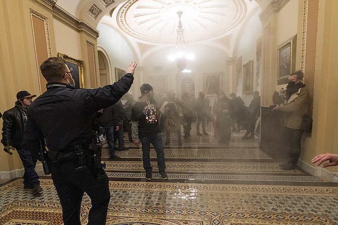 RIOTERS are confronted by U.S. Capitol Police officers inside the Capitol, January 6, in Washington.
(AP Photo/Manuel Balce Ceneta)