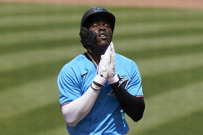 Miami Marlins' Jazz Chisholm reacts as he crosses home plate after hitting a solo home run during the fifth inning of a spring training baseball game against the New York Mets, Wednesday, March 17, 2021, in Jupiter, Fla. (AP Photo/Lynne Sladky)