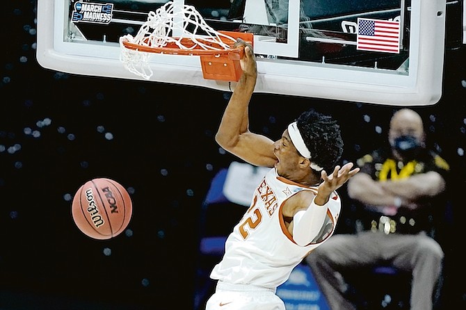 Texas’ Kai Jones dunks the ball against Abilene Christian during the first half of a college basketball game in the first round of the NCAA tournament at Lucas Oil Stadium in Indianapolis Saturday, March 20.

(AP Photo/Mark Humphrey)