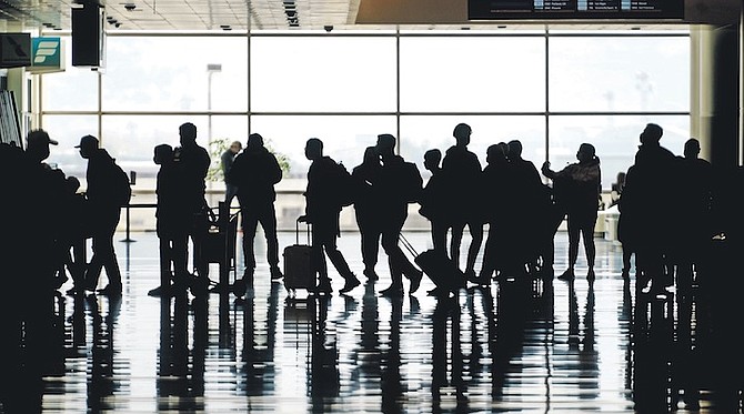 SILHOUETTES of travellers at Salt Lake City International Airport - as tourism is left a shadow of its former self in the US. Photo: Rick Bowmer/AP