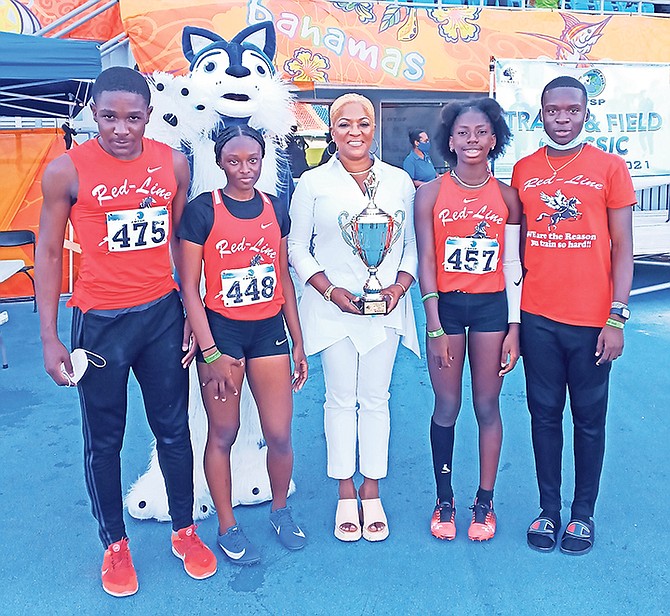 Red-Line Athletics’ under-20 mixed relay team of Otto Laing, Shimar Bain, Asia Butler and Lacarthea Cooper receive their trophy from ‘Golden Girl’ Eldece Clarke.