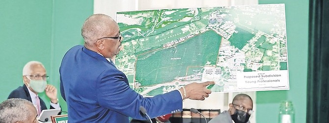 PRIME Minister Dr Hubert Minnis shows plans for the proposed upscale community in western New Providence yesterday. 
PHOTO: Donavan McIntosh/ Tribune staff