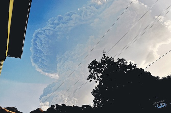 ASH rises into the air as La Soufriere volcano erupts on the eastern Caribbean island of St. Vincent, Tuesday. (AP Photo/Orvil Samuel)