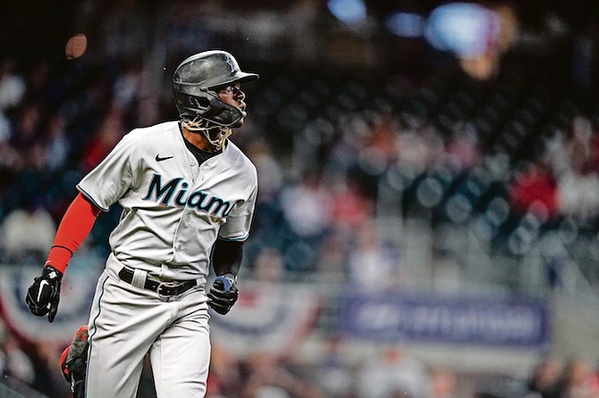 Jazz Chisholm Jr watches his home run during the third inning against the Atlanta Braves last night in Atlanta.
(AP Photos/Brynn Anderson)