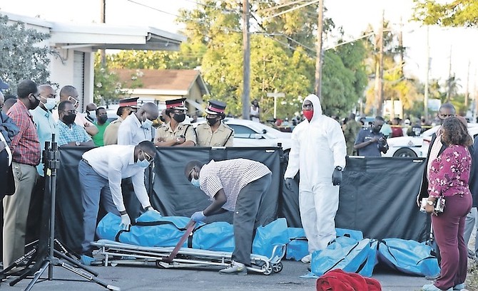 THE bodies of the shooting victims are removed from the scene. Photo: Donavan McIntosh/Tribune staff