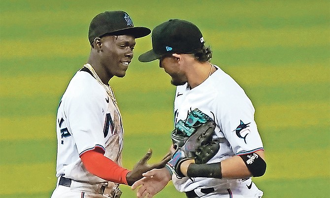 Jazz Chisholm Jr and shortstop Miguel Rojas celebrate their 3-0 win over the Baltimore Orioles yesterday in Miami.