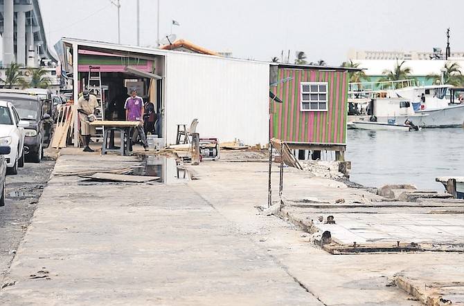 CLEAN-up under way after the fire at Potter’s Cay dock this week. Photo: Donovan McIntosh/Tribune Staff