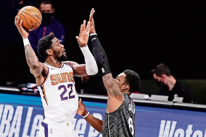 Phoenix Suns centre Deandre Ayton (22) shoots with Brooklyn Nets forward Jeff Green (8) defending during the third quarter last night in New York.
