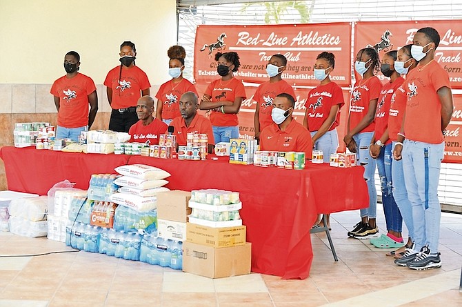Coaches and athletes of Red-Line Athletics pose with the food items they donated to Great Commission Ministries International. 
Photos courtesy of Kermit Taylor
