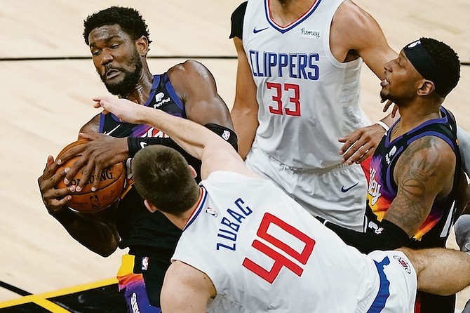 Phoenix Suns centre Deandre Ayton rebounds over Los Angeles Clippers centre Ivica Zubac (40) during the first half on Wednesday night in Phoenix.

(AP Photo/Matt York)