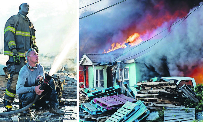 Firefighters tackling the blaze. 
Photos: Racardo Thomas