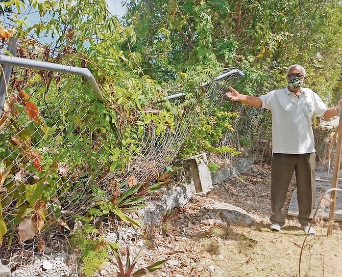 DR Alfred Brathwaite shows the damage to his property.