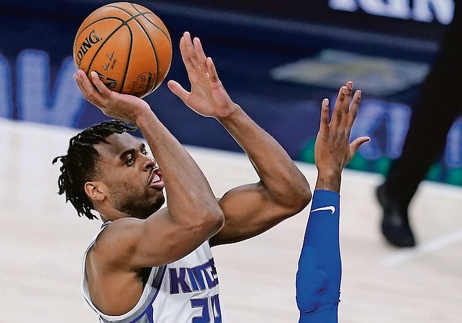 Sacramento Kings’ Buddy Hield (24) shoots over Indiana Pacers’ Aaron Holiday during the first half last night in Indianapolis. Hield had 16 points, eight rebounds, eight assists and two steals.  
(AP Photo/Darron Cummings)