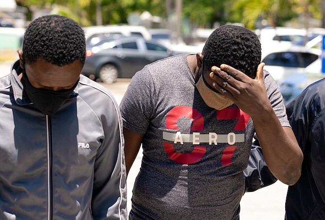 REGINALD and Rishkard Jeudy outside court yesterday. The two Haitian Nationals admitted possession of forged documents.