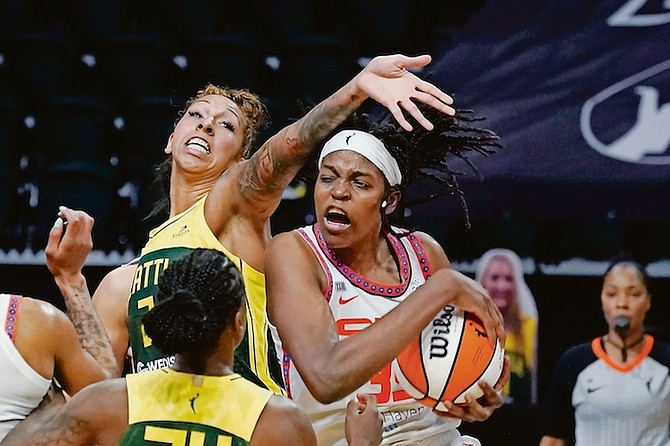 Connecticut Sun’s Jonquel Jones, right, grabs a rebound next to Seattle Storm’s Mercedes Russell in overtime of a WNBA basketball game on Tuesday in Everett, Washington. The Storm won 90-87. Photo: Elaine Thompson/AP