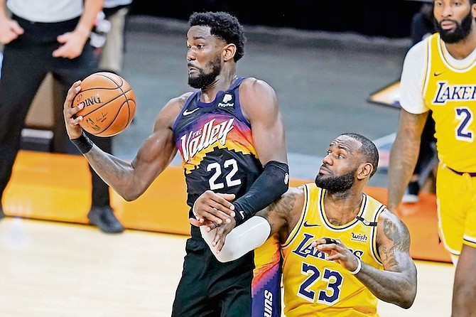 PHOENIX Suns centre Deandre Ayton grabs a rebound in front of Los Angeles Lakers forward LeBron James during the second half of Game 2 of their NBA basketball first-round playoff series on Tuesday
in Phoenix.