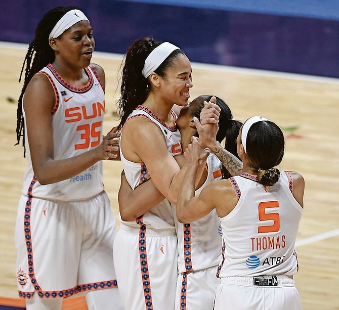 Sun forward Brionna Jones, centre, is congratulated by teammates Jonquel Jones, left, Jasmine Thomas (5) and Briann January after being fouled. (AP)