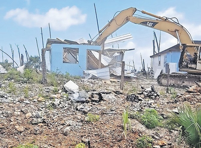 DEMOLITION work taking place recently in The Farm shanty town in Abaco - but a court injunction has now been extended to cover the island and bring a halt to shanty town clearances there.