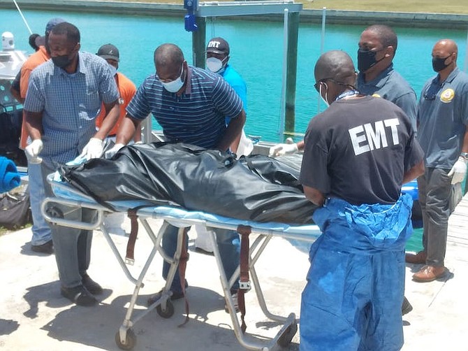 The body of one of the two fatalities on a stretcher at the Police Marine Base in Lucaya. Photo: Denise Maycock/Tribune staff