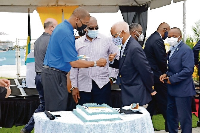 Fist bumps with Minister of Tourism Dionisio D’Aguilar as Prime Minister Dr Hubert Minnis watches on during the return of cruise ships to Freeport at the weekend.
