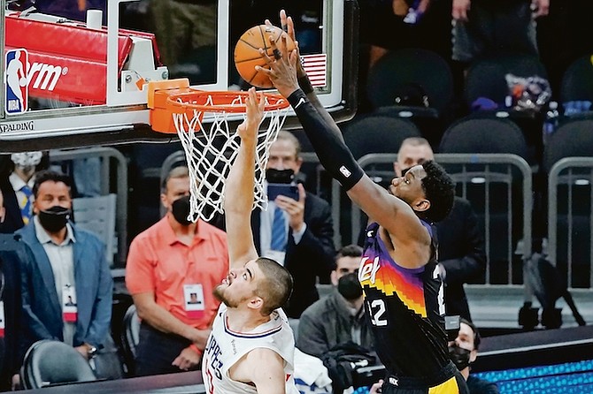 Phoenix Suns centre Deandre Ayton, right, scores over Los Angeles Clippers centre Ivica Zubac during the second half of Game 2 of the NBA basketball Western Conference Finals, Tuesday, in Phoenix. (AP Photo/Matt York)