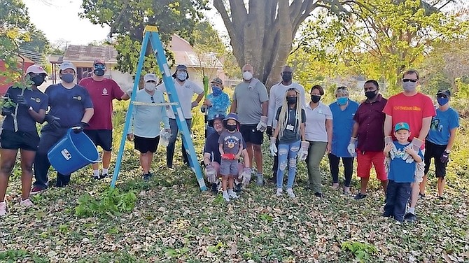 MEMBERS of the Rotary Club of East Nassau and their families joined with the Bahamas National Trust to clear the plot of land to plant a fruit forest for the Fox Hill Community.