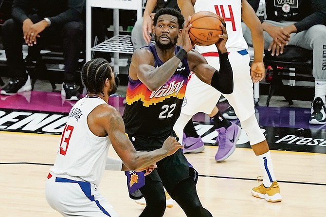 Phoenix Suns centre Deandre Ayton (22) shoots as Los Angeles Clippers guard Paul George (13) defends during the first half of game 5 of the NBA Western Conference Finals last night in Phoenix.

(AP Photo/Matt York)