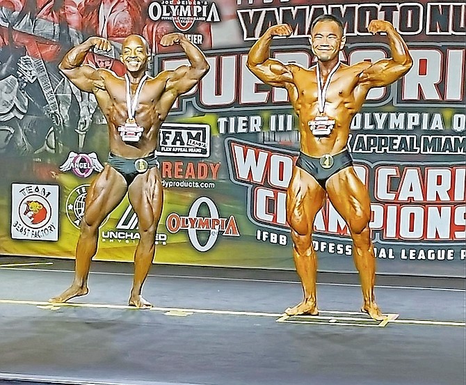 BAHAMIAN Paul Wilson, left, on stage at International Federation of Bodybuilding and Fitness (IBBF) Pro League World Caribbean Championships at Grand Hyatt, Baha Mar on Saturday.