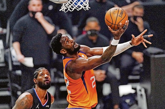 Phoenix Suns centre Deandre Ayton, right, shoots as Los Angeles Clippers guard Paul George defends during the first half in Game 6 of the NBA Western Conference Finals last night in Los Angeles. (AP Photo/Mark J Terrill)