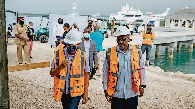 Michael Wiener shows Prime Minister Dr Hubert Minnis construction work at Briland Club at an event on Friday to mark the launch of the marina.