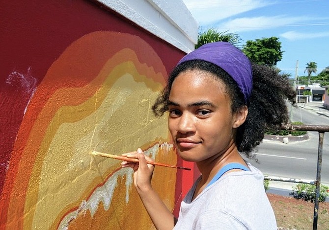 KATLYN paints her mural for all to see.