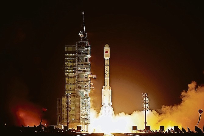 A Long March 2F rocket carrying the country’s first space laboratory module Tiangong-1 lifts off from the Jiuquan Satellite Launch Center on September 29, 2011, in Jiuquan, Gansu province of China.