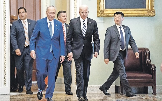 SENATE Majority Leader Sen Chuck Schumer of NY, walks with President Joe Biden as he arrives on Capitol Hill to meet with Senate Democrats. President Biden has spoken out over new voter laws, which are more restrictive. Photo: Evan Vucci/AP