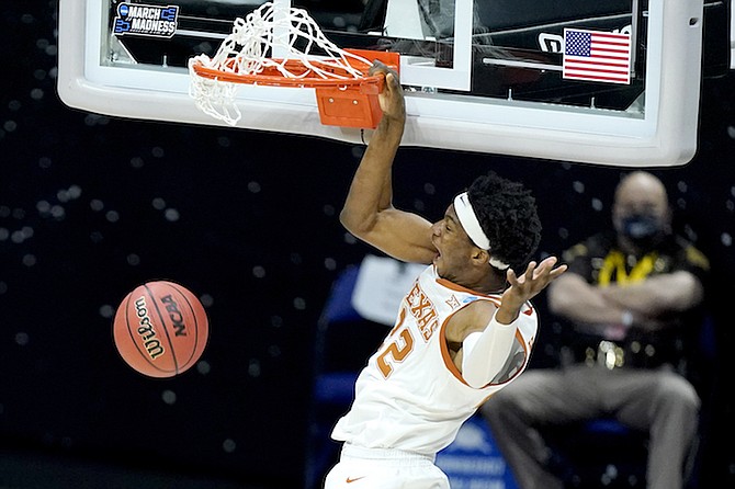 Texas’ Kai Jones dunks against Abilene Christian during the first half of a college basketball game in the first round of the NCAA tournament at Lucas Oil Stadium in Indianapolis on March 20, 2021. Jones is a first-round prospect in tonight’s NBA draft.

(AP Photo/Mark Humphrey)