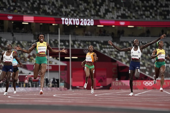 Elaine Thompson-Herah, third left, of Jamaica, celebrates as she wins the final of the women's 200-metres ahead of Christine Mboma, second right, of Namibia, at the 2020 Summer Olympics, Tuesday in Tokyo. Shaunae Miller-Uibo can be seen second from left. (AP Photo/Petr David Josek)