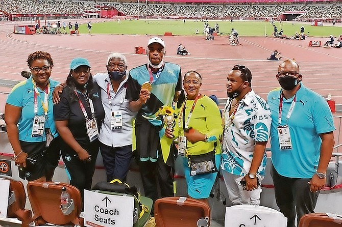 Gold medallist Steven Gardiner is flanked by Bahamian officials, including Dawn Woodside-Johnson, Oria Wood-Knowles, Mike Sands, Cora Hepburn, Derron Donaldson and Dorian Roach in Tokyo.