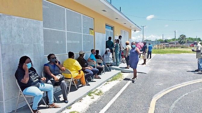 PEOPLE outside the Susan J Wallace Centre in Freeport waiting to be vaccinated.
Photo: Denise Maycock/Tribune Staff