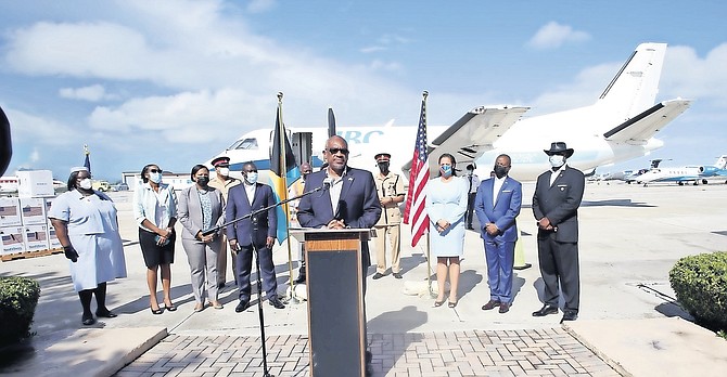 PRIME Minister Dr Hubert Minnis welcoming the arrival of the shipment of Pfizer vaccine yesterday morning at Jet Nassau, alongside US Embassy Charge d’Affaires Usha Pitts, and officials.
Photo: Patrick Hanna/BIS