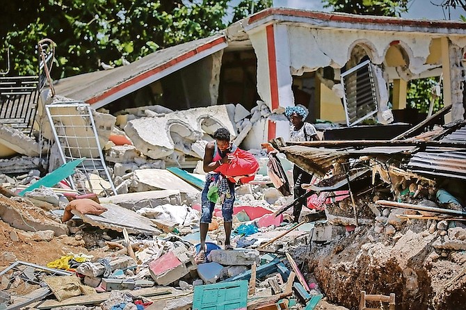 LOCALS recover their belongings from their homes destroyed in the earthquake in Camp-Perrin, Les Cayes, Haiti, Sunday.
(AP Photo/Joseph Odelyn)