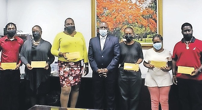 THE FAMILIES of Nurse Sherrilyn Charlton-Bain and custodian Marion Burrows-McKinney were presented with cheques yesterday.