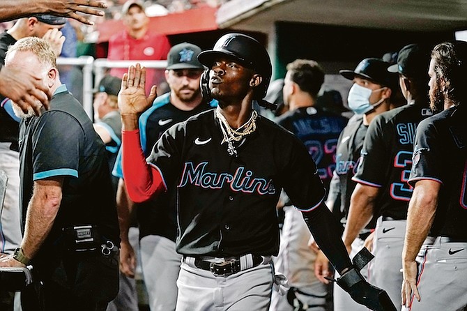 Marlins’ Jasrado “Jazz” Chisholm Jr, centre, celebrates with teammates after scoring during the eighth inning against the Cincinnati Reds on Saturday in Cincinnati.