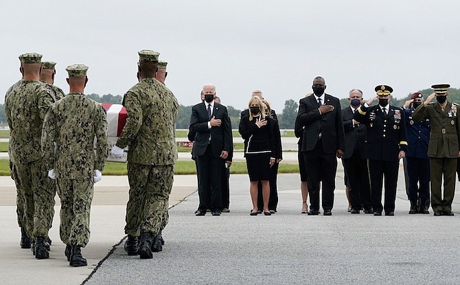 PRESIDENT Joe Biden watches as a Navy carry team moves a transfer case containing the remains of Navy Corpsman Maxton W Soviak, 22, of Berlin Heights, Ohio, at Dover Air Force Base, Delaware yesterday. According to the Department of Defense, Soviak died in an attack at Afghanistan’s Kabul airport, along with 12 other US service members. Photo: Manuel Balce Ceneta/AP
