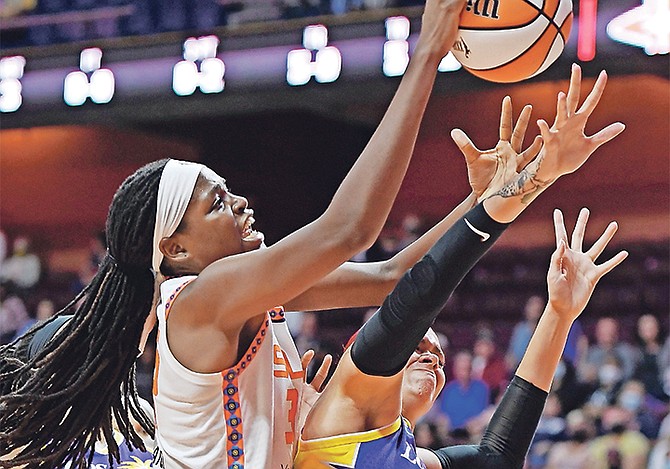 Connecticut Sun forward Jonquel Jones, front left, battles Los Angeles Sparks centre Amanda Zahui B. for the ball during their WNBA game on Saturday in Uncasville, Conn. Last night, Jones scored 21 of her career-high tying 31 points in the first half and Connecticut beat the Washington Mystics 85-75 for the Sun’s ninth straight victory.
(Sean D Elliot/The Day via AP)