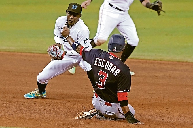 Washington Nationals’ Alcides Escobar (3) is safe on second as Miami Marlins second baseman Jazz Chisholm Jr is late with the tag during the sixth of a baseball game yesterday in Miami.

(AP Photo/Marta Lavandier)