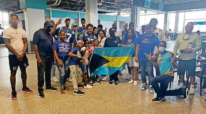 PROUD TO BE BAHAMIAN - Members of the Strachan family celebrate with Minister of Youth, Sports and Culture Mario Bowleg following the Colts’ win over the Miami Dolphins.